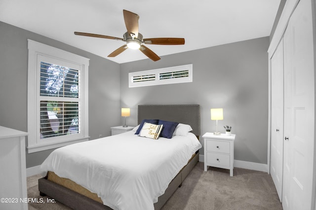 carpeted bedroom featuring a closet and ceiling fan