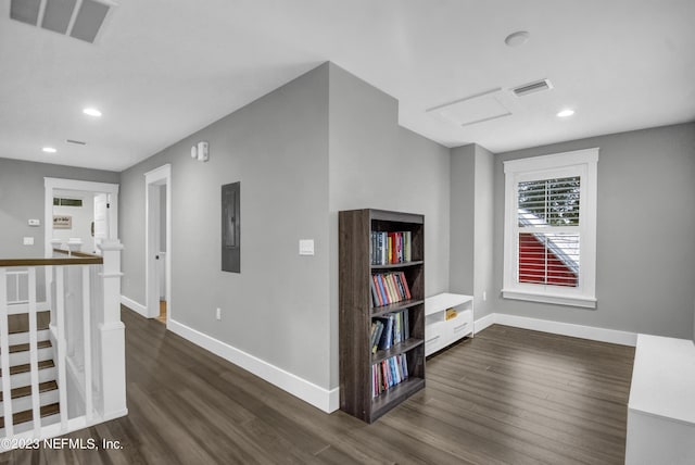 hallway featuring dark wood-type flooring and electric panel