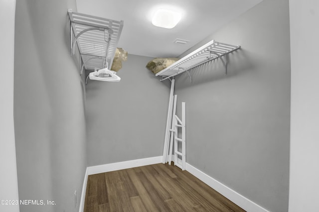 spacious closet featuring dark hardwood / wood-style floors