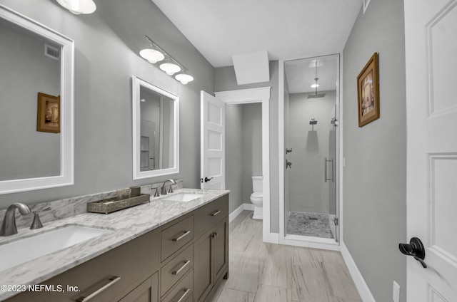 bathroom featuring vanity, toilet, and an enclosed shower