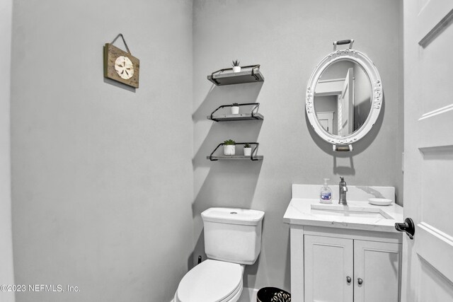 bathroom featuring toilet and large vanity