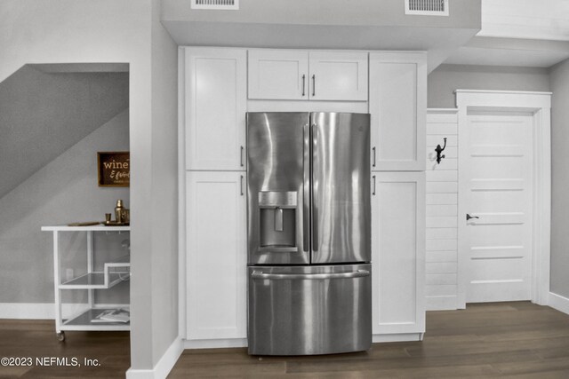 kitchen with stainless steel refrigerator with ice dispenser, white cabinetry, and dark hardwood / wood-style flooring