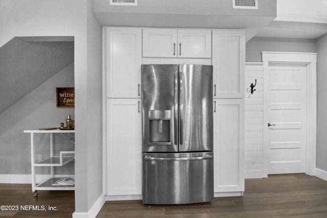 kitchen featuring stainless steel fridge with ice dispenser, dark hardwood / wood-style floors, and white cabinets