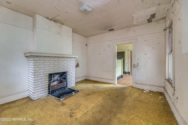 unfurnished living room featuring a fireplace