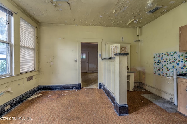 empty room featuring dark colored carpet