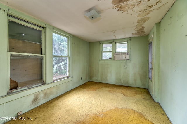 spare room featuring light colored carpet and cooling unit