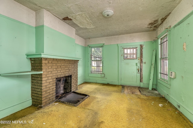 unfurnished living room featuring a fireplace