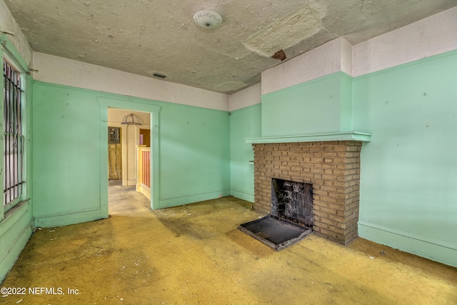 unfurnished living room featuring a brick fireplace