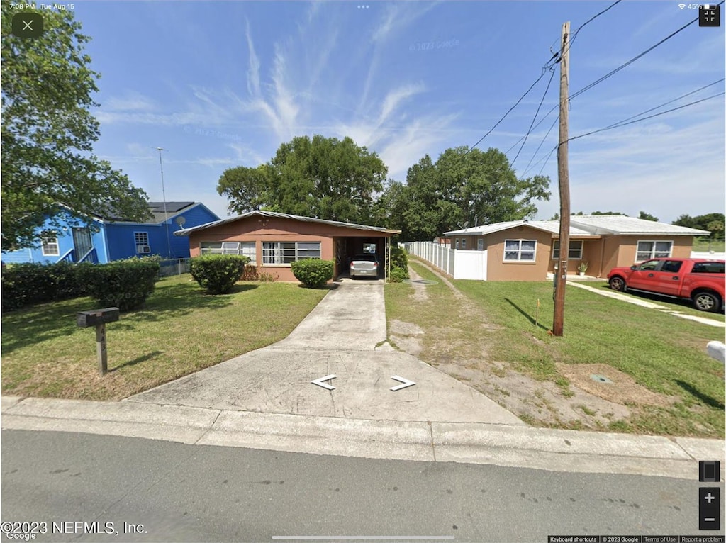 ranch-style house with a carport and a front yard