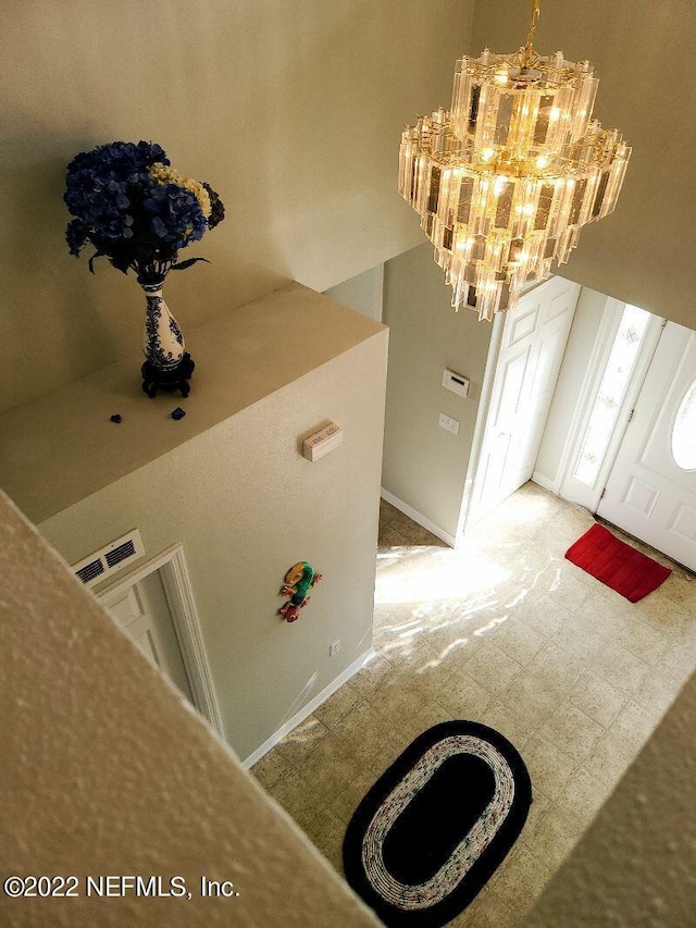 foyer entrance featuring a notable chandelier