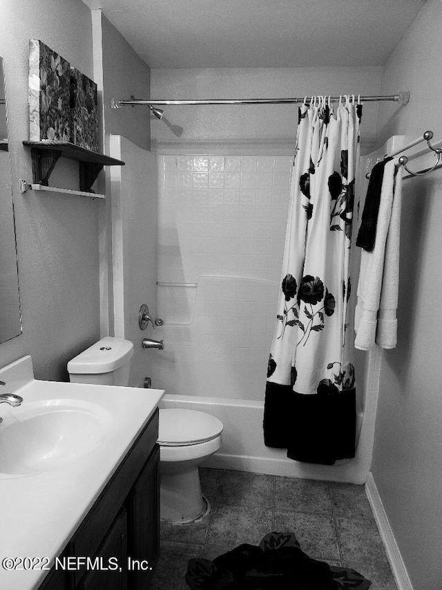 full bathroom with tile patterned flooring, shower / bath combination with curtain, toilet, and vanity