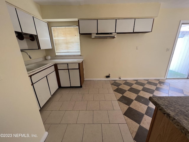 kitchen with white cabinetry and sink