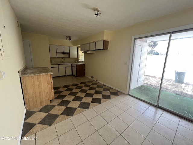 kitchen with sink and light tile patterned floors