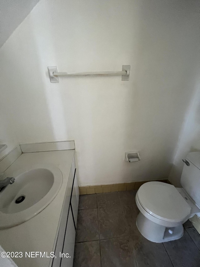 bathroom with tile patterned floors, vanity, and toilet