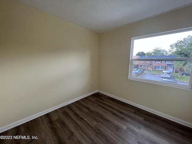 empty room with dark hardwood / wood-style floors