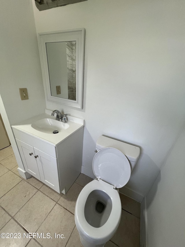 bathroom featuring toilet, vanity, and tile patterned floors