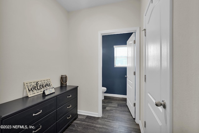 bathroom with hardwood / wood-style floors and toilet