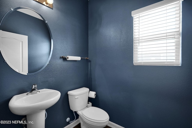 bathroom featuring toilet and sink