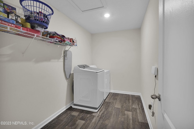 laundry area featuring dark wood-type flooring and washing machine and clothes dryer