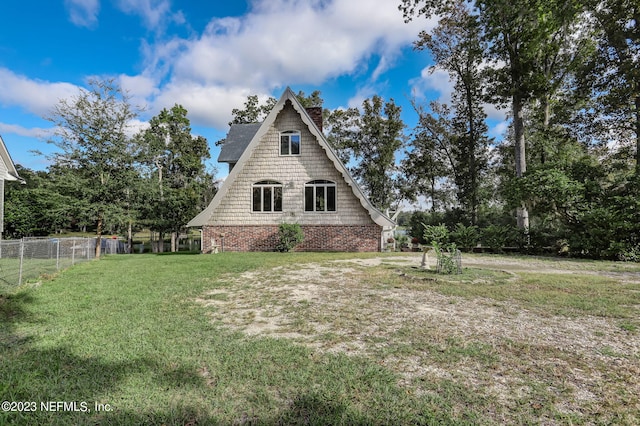 view of side of home with a yard