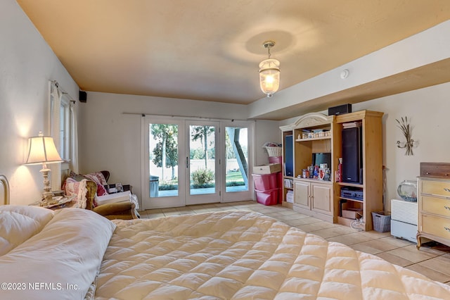 bedroom with light tile patterned floors and access to outside