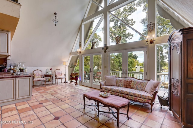 sunroom with lofted ceiling, plenty of natural light, and french doors