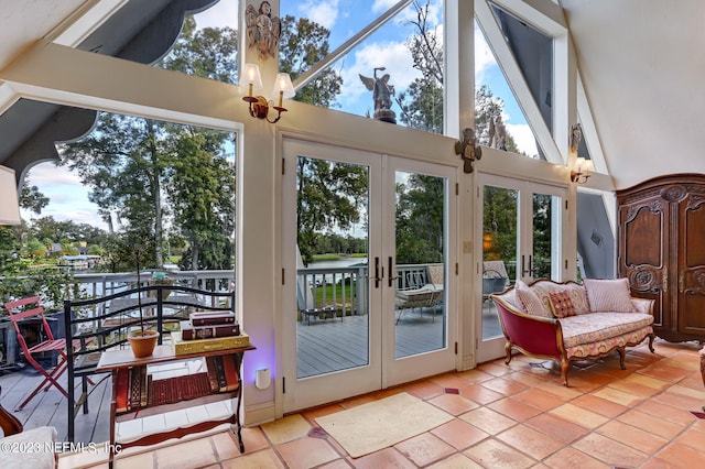 interior space with french doors and high vaulted ceiling