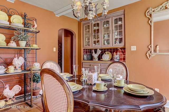 tiled dining room featuring a notable chandelier