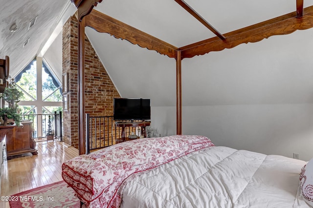 bedroom with vaulted ceiling and hardwood / wood-style floors