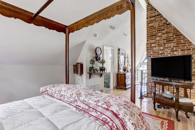 bedroom with light hardwood / wood-style flooring and vaulted ceiling