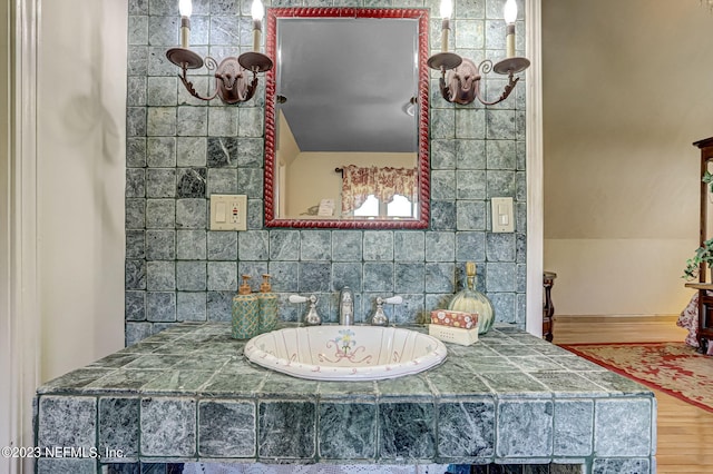 bathroom featuring hardwood / wood-style flooring, a bathing tub, and sink