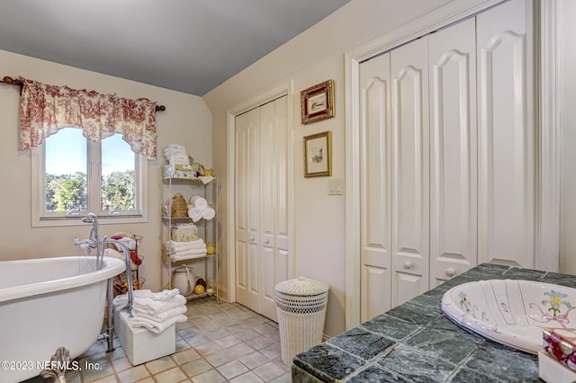 bathroom featuring a bathtub and tile patterned flooring