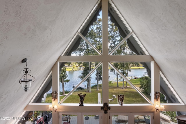 room details featuring a textured ceiling and a water view