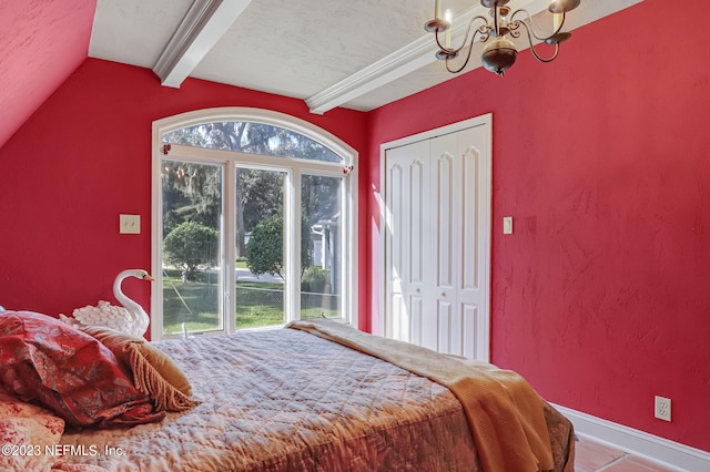 tiled bedroom featuring a textured ceiling, lofted ceiling with beams, an inviting chandelier, and a closet