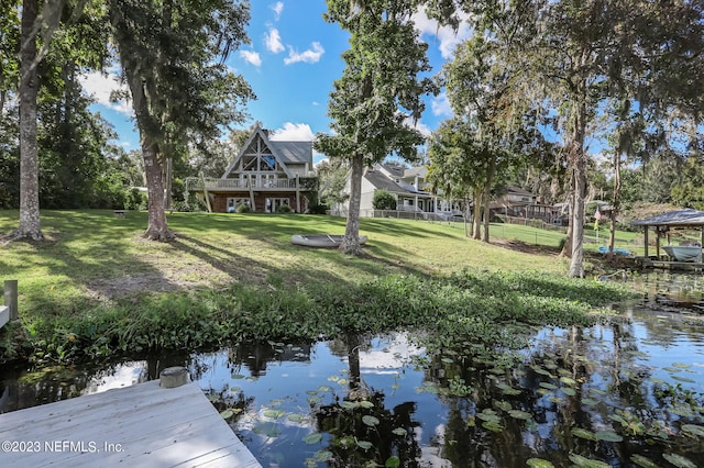 dock area featuring a yard and a water view