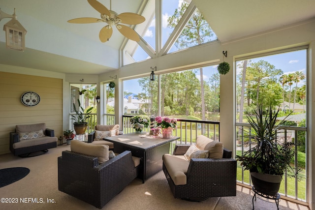 sunroom with lofted ceiling and a ceiling fan