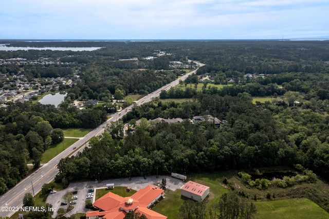 aerial view featuring a water view and a view of trees