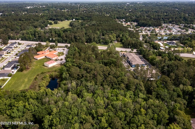 birds eye view of property featuring a view of trees