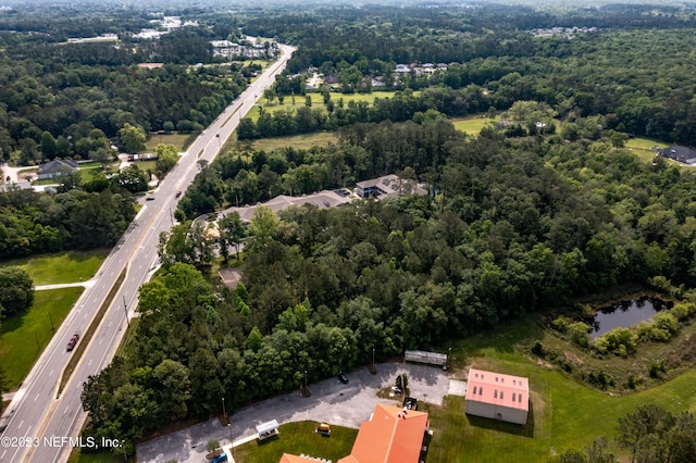 drone / aerial view featuring a water view and a view of trees