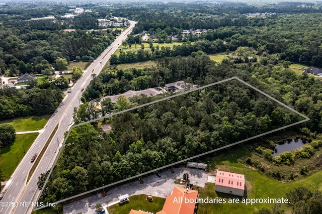 birds eye view of property with a wooded view