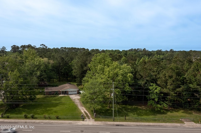 birds eye view of property with a view of trees