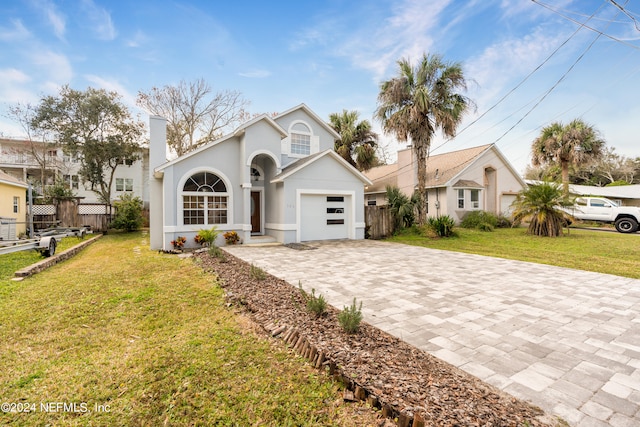 view of front of property featuring a front lawn and a garage