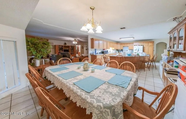 dining area featuring ceiling fan with notable chandelier and light tile patterned floors