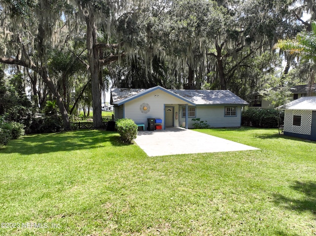 back of house featuring a yard and a patio area