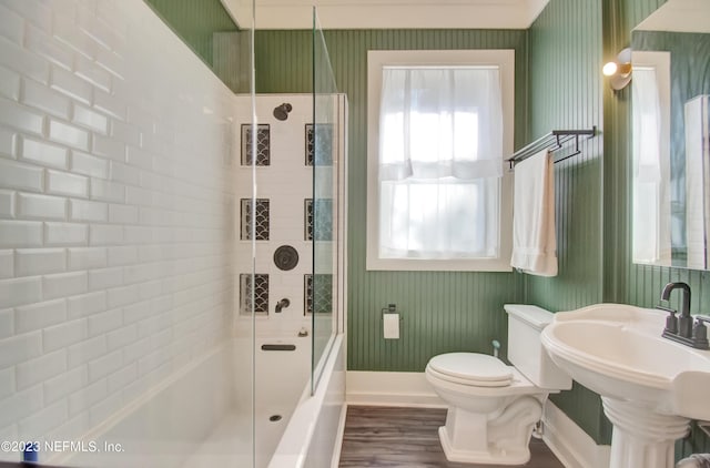 full bathroom featuring wood-type flooring, toilet, combined bath / shower with glass door, and plenty of natural light