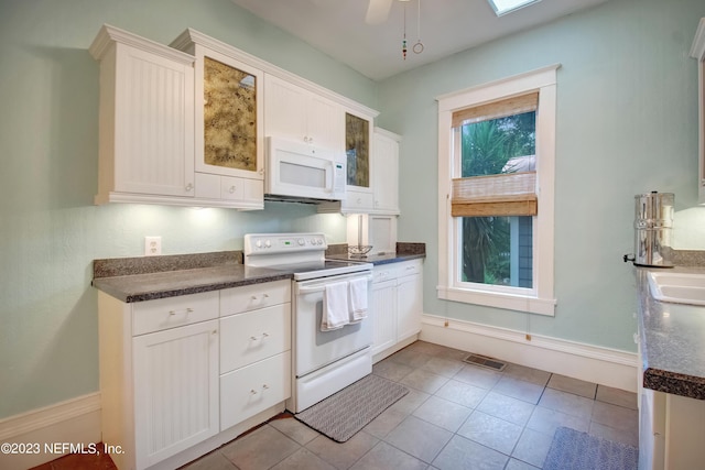 kitchen featuring white cabinetry, light tile patterned floors, white appliances, and ceiling fan