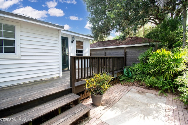 wooden terrace featuring a patio area