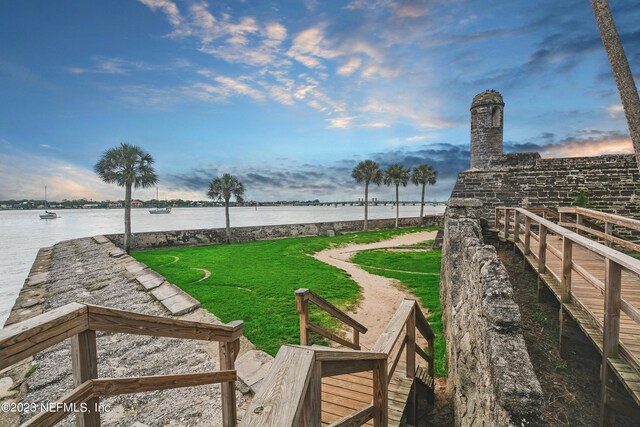 exterior space featuring a water view and a lawn