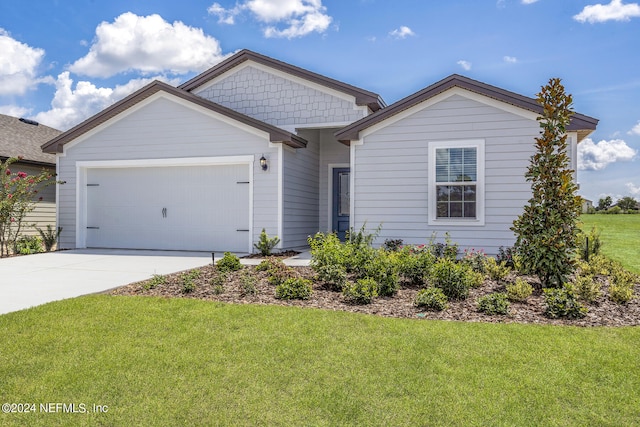 ranch-style home with a garage, driveway, and a front yard