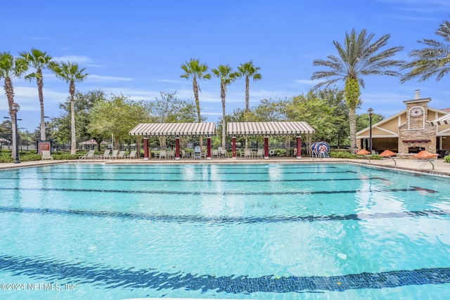 pool with a patio and fence